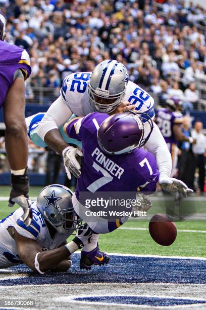 Christian Ponder of the Minnesota Vikings is hit and fumbles the ball in the end zone by Jarius Wynn of the Dallas Cowboys at AT&T Stadium on...