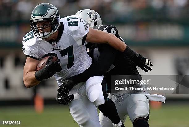 Brent Celek of the Philadelphia Eagles gets wrapped up by Kevin Burnett of the Oakland Raiders during the second quarter at O.co Coliseum on November...