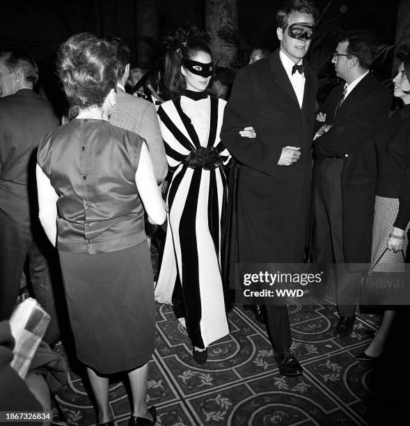 Couple in masks arriving at Truman Capote's Black and White Ball in the Grand Ballroom at the Plaza Hotel in New York City
