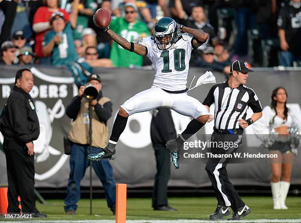 DeSean Jackson of the Philadelphia Eagles leaps over the goal line scoring on a forty six yard touchdown pass against the Oakland Raiders during the...