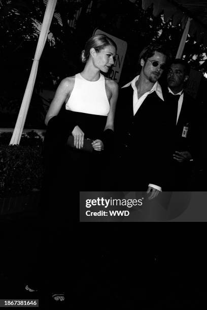 Outtake; Also ran W 3/1996 p.78; Gwyneth Paltrow wearing an ultra-ladylike black and white Calvin Klein gown with boyfriend Brad Pitt attend the...