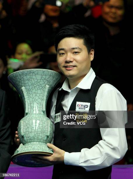 Ding Junhui of China poses with the trophy after winning the final match against Marco Fu of Hong Kong during the 2013 International Snooker...