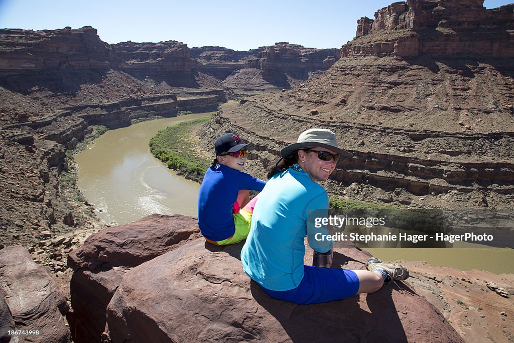 Woman and boy sitting on rock