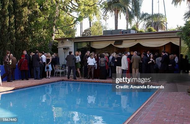 Guests mingle next to a poolside at a Pre-Oscar reception hosted by Bonnie and John Cacavas and the Society of Composers and Lyricists to honor the...
