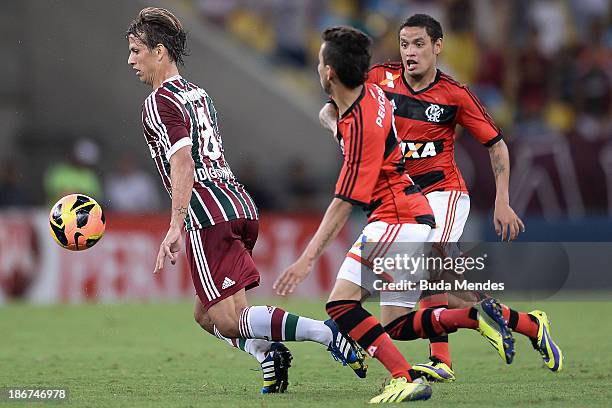 Rafinha and Carlos Eduardo of Flamengo struggles for the ball with a Diguinho of Fluminense during a match between Flamengo and Fluminense as part of...