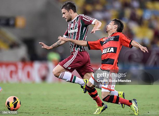 Rafinha of Flamengo struggles for the ball with a Rafael Sobis of Fluminense during a match between Flamengo and Fluminense as part of Brazilian...