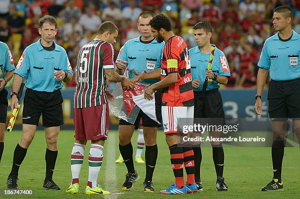 Edinho of Fluminense and Wallace of Flamengo exchange streamer of the teams before the match between Flamengo and Fluminense for the Brazilian Series...