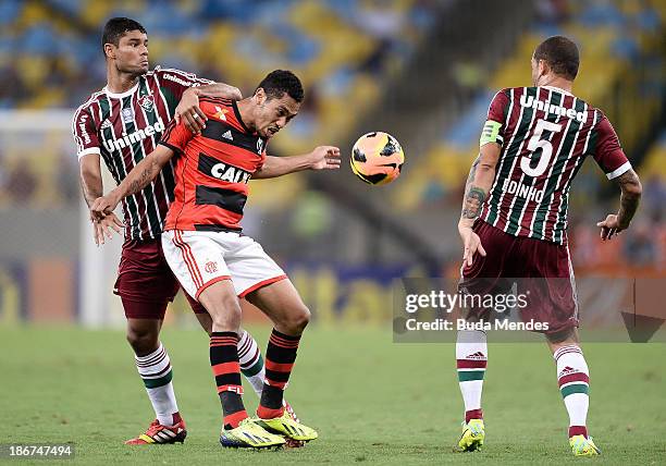 Hernane of Flamengo struggles for the ball with a Gum and Edinho of Fluminense during a match between Flamengo and Fluminense as part of Brazilian...