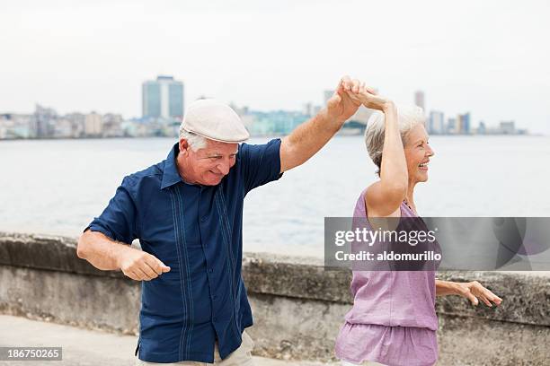 senior couple dancing and having fun - havana dancing stock pictures, royalty-free photos & images