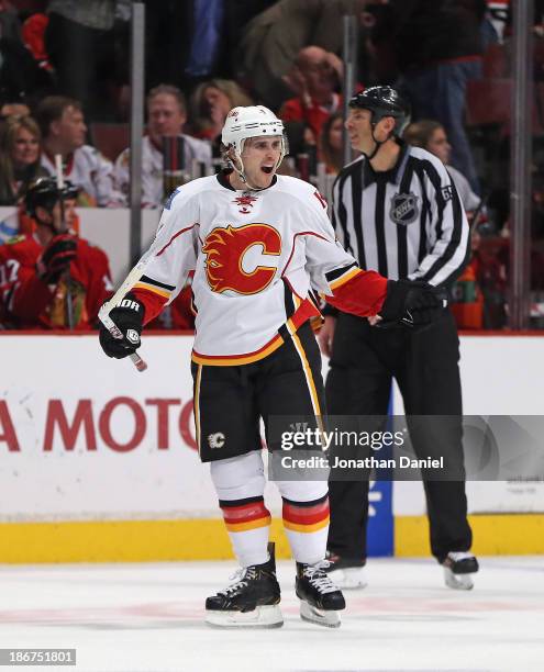 Kris Russell of the Calgary Flames celebrates his game-winning overtime goal against the Chicago Blackhawks at the United Center on November 3, 2013...