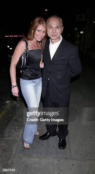 Shoe Designer Jimmy Choo and an unidentified friend arrive at the Sketch Nightclub March 22, 2003 in London.