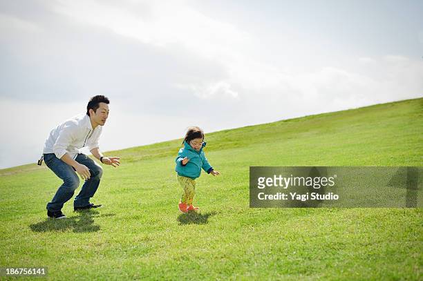 family enjoying day out in the grass - 家族　日本人　走る ストックフォトと画像