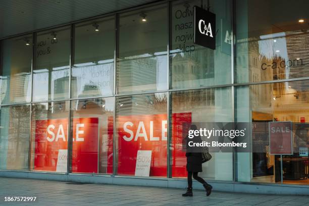 Sales signs in the window of a C&A Group department store in Warsaw, Poland, on Friday, Dec. 22, 2023. The central bank halted interest rate cuts...