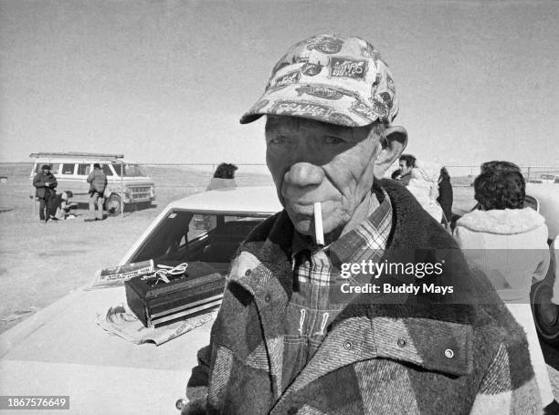 Frustrated man stands in the cold while awaiting word from prison officials on the fate of his inmate son, in the aftermath of the 1980 prison riots...