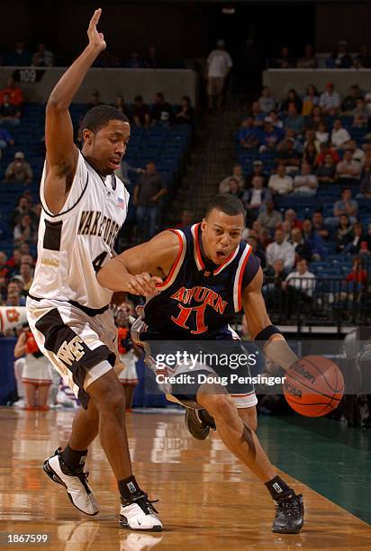 Derrick Bird of the Auburn University Tigers drives the ball past Taron Downey of the Wake Forest University Deacons in the second round of the East...