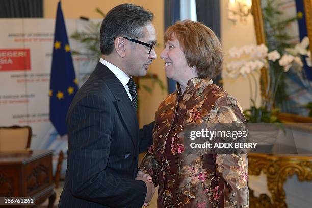 High Representative of the European Union for Foreign Affairs and Security Policy Catherine Ashton shakes hand with Indonesia's Foreign Minister...