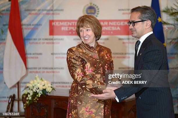 High Representative of the European Union for Foreign Affairs and Security Policy Catherine Ashton shakes hand with Indonesia's Foreign Minister...