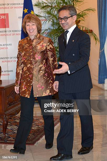 High Representative of the European Union for Foreign Affairs and Security Policy Catherine Ashton walks next to Indonesia's Foreign Minister Marty...