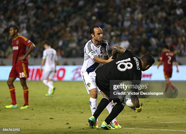 Landon Donovan of the Los Angeles Galaxy helps goalkeeper Nick Rimando of Real Salt Lake back to his feet in the second half of their MLS match at...