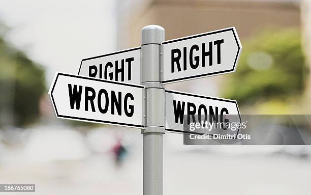 street signs showing right and wrong options - wrong direction stock pictures, royalty-free photos & images