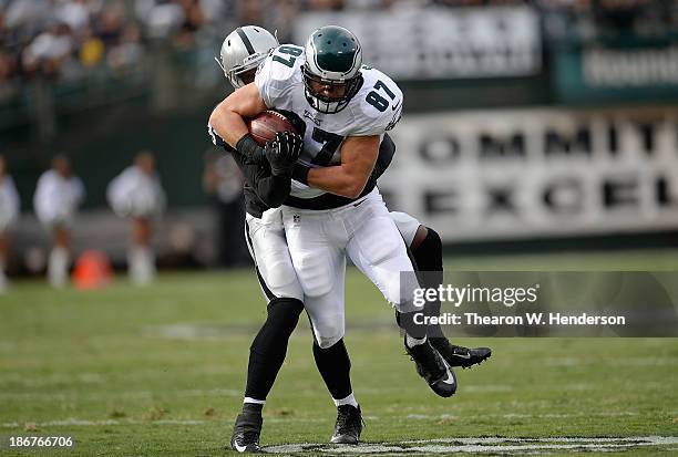 Brent Celek of the Philadelphia Eagles gets wrapped up by Kevin Burnett of the Oakland Raiders during the second quarter at O.co Coliseum on November...