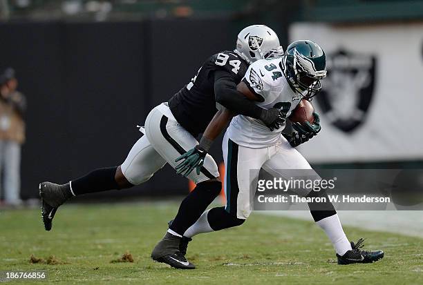 Bryce Brown of the Philadelphia Eagles gets wrapped up by Kevin Burnett of the Oakland Raiders during the third quarter at O.co Coliseum on November...