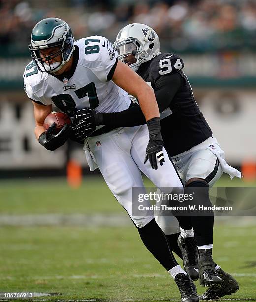 Brent Celek of the Philadelphia Eagles gets wrapped up by Kevin Burnett of the Oakland Raiders during the second quarter at O.co Coliseum on November...