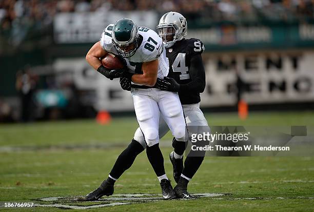 Brent Celek of the Philadelphia Eagles gets wrapped up by Kevin Burnett of the Oakland Raiders during the second quarter at O.co Coliseum on November...