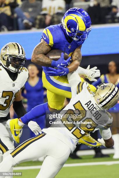 Inglewood, CA Kyren Williams of the Los Angeles Rams scores a 10 yard touchdown against Paulson Adebo of the New Orleans Saints during the third...