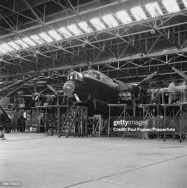 An Avro Lancaster heavy bomber under construction at an Avro factory in Greater Manchester, 16th March 1942. The aircraft entered service with the...