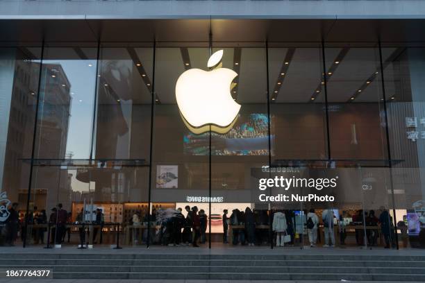 Citizens are walking past an Apple store in Shanghai, China, on December 22, 2023.