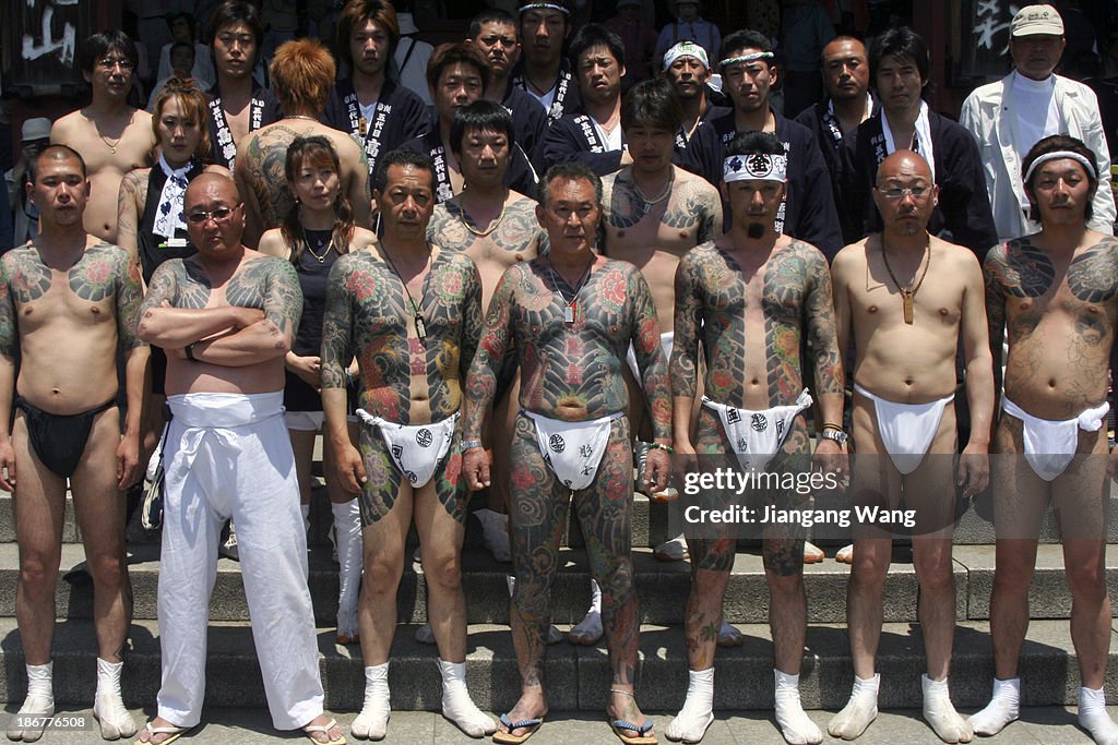 Yakuza members display their full-body tattoos