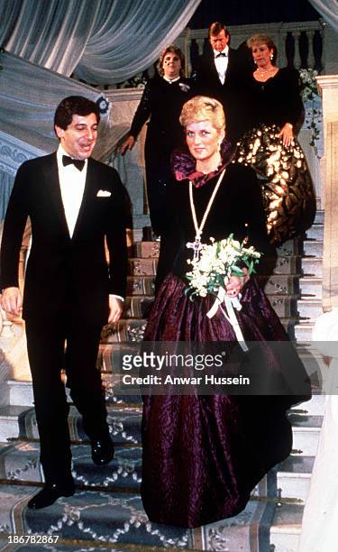 Diana, Princess of Wales, wearing a long purple Catherine Walker evening gown, attends a charity evening on behalf of Birthright at Garrard the...