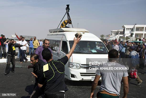 Egyptian Muslim brotherhood supporters of ousted Islamist president Mohamed Morsi attack an Egyptian satellite channel CBC microbus outside of Police...