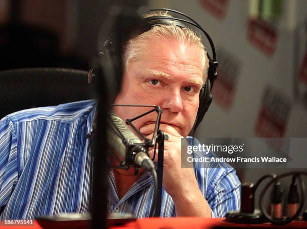 Councillor Doug Ford listens to his brother, Mayor Rob Ford, during their radio show at CFRB Newstalk 1010. November 3, 2013.