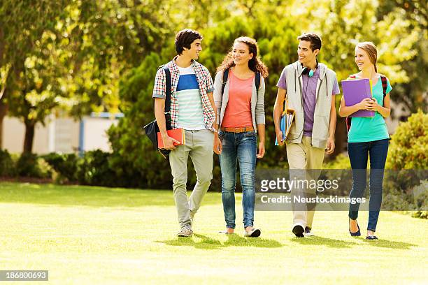 college students walking on campus lawn - students college beautiful bildbanksfoton och bilder