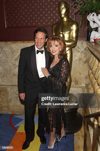 Theater company manager Percy Gibson and his wife Joan Collins arrive at the official Academy of Motion Picture Arts & Sciences Oscar Night Viewing...