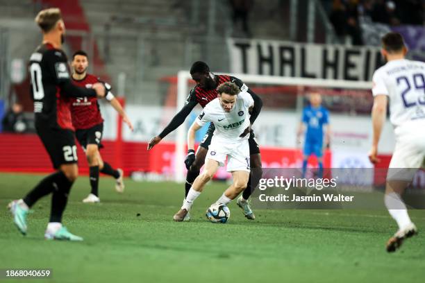Pingdwinde Beleme of FC Ingolstadt 04 challenges Mirnes Pepic of FC Erzgebirge Aue during the 3. Liga match between FC Ingolstadt 04 and Erzgebirge...