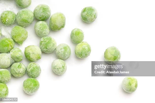 scattered frozen peas - frozen vegetables stock pictures, royalty-free photos & images