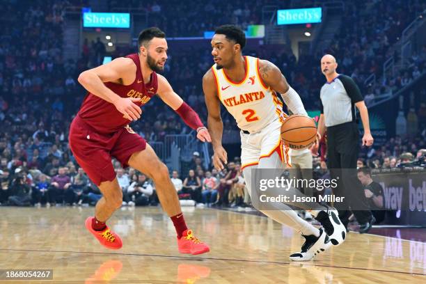 Trent Forrest of the Atlanta Hawks drives to the basket around Max Strus of the Cleveland Cavaliers during the first quarter at Rocket Mortgage...