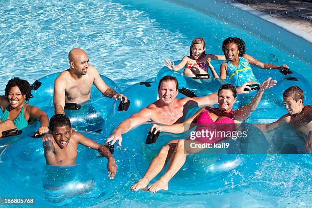 group of people on innertubes at water park - trögflytande bildbanksfoton och bilder