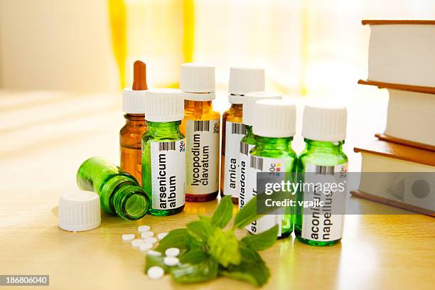 homeopathic medicine: remedies and books - lycopodiaceae stock pictures, royalty-free photos & images