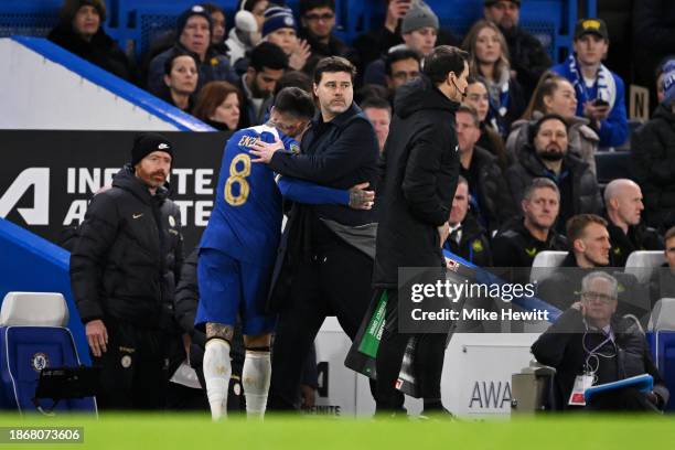 Mauricio Pochettino, Manager of Chelsea interacts with Enzo Fernandez of Chelsea after he leaves the pitch injured during the Carabao Cup Quarter...