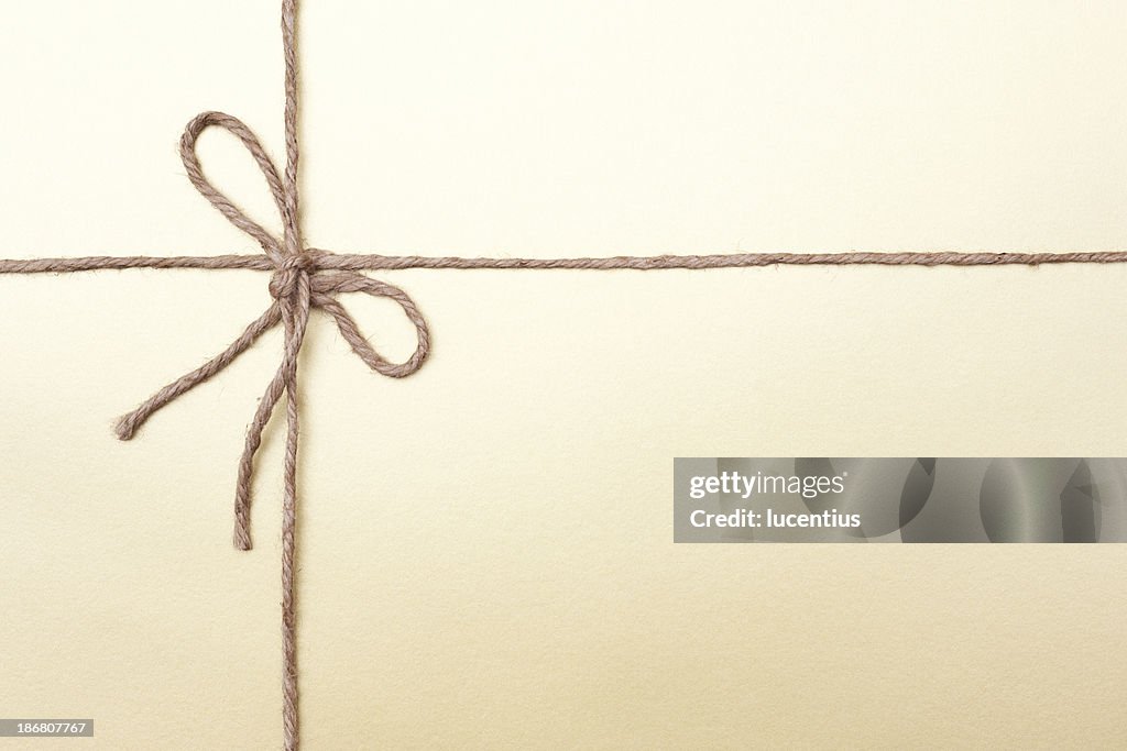 Gold coloured packaging with knotted string