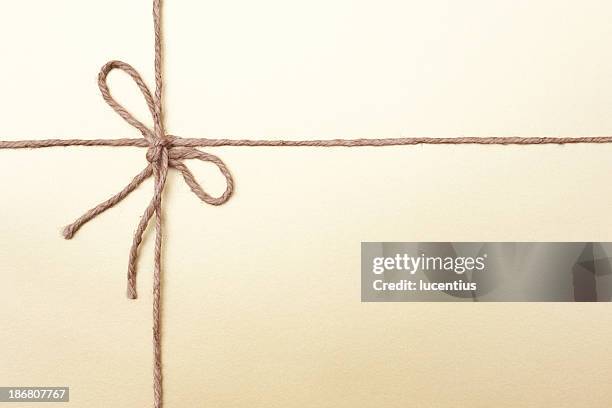 gold coloured packaging with knotted string - tied knot stock pictures, royalty-free photos & images