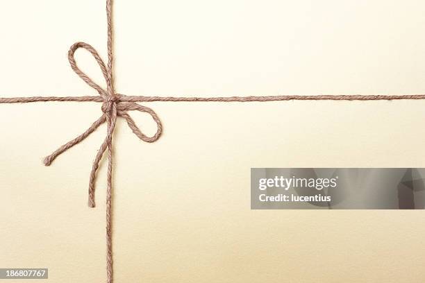 gold coloured packaging with knotted string - ball of string stock pictures, royalty-free photos & images