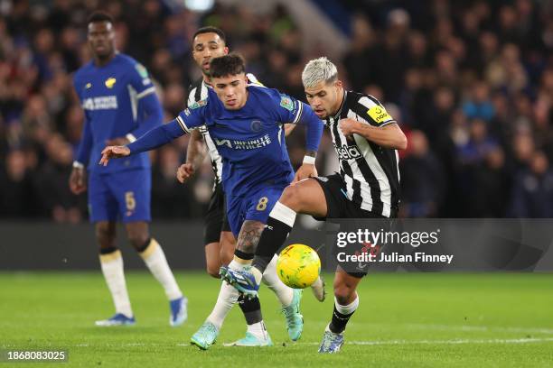 Bruno Guimaraes of Newcastle United is challenged by Enzo Fernandez of Chelsea during the Carabao Cup Quarter Final match between Chelsea and...