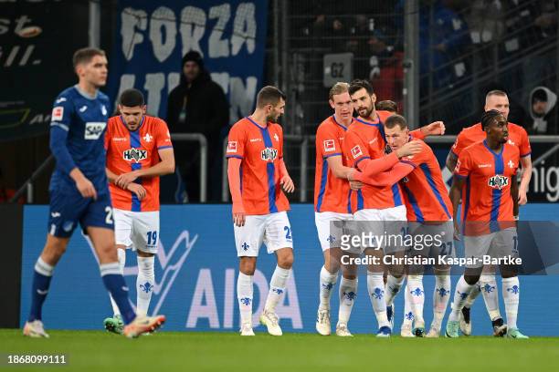 Tim Skarke of SV Darmstadt 98 celebrates with teammates after scoring their team's second goal during the Bundesliga match between TSG Hoffenheim and...