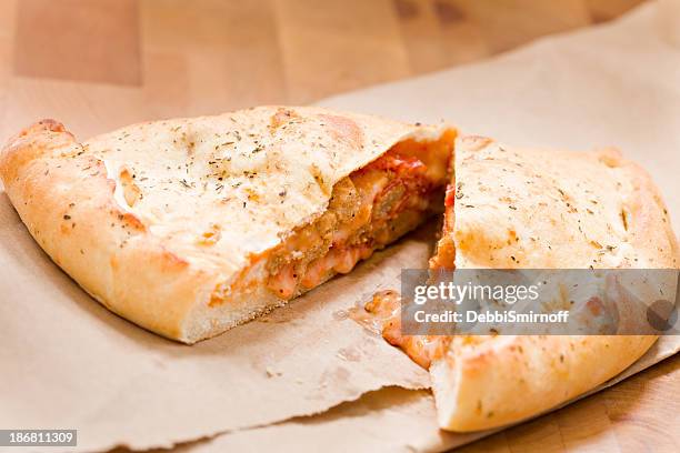 sliced calzone - stuffing stock pictures, royalty-free photos & images