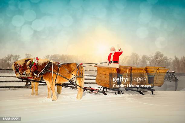 friendly santa waving to viewer with sleigh and horse team - santa riding stock pictures, royalty-free photos & images